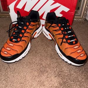 Nike Air Max Plus Vibrant Orange, Gold, and Black Athletic Shoes